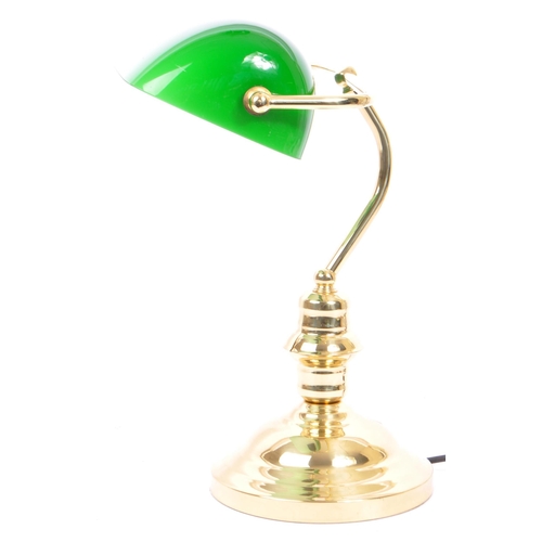 709 - A vintage 20th Century bankers office table lamp light. Having a green glass swinging shade, with br... 