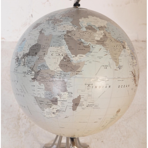 712 - A contemporary globe of cream colourway sitting on a silver floor standing stainless steel stand. Me... 