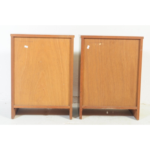 717 - A pair of retro vintage mid 20th century teak wood bedside cabinet / tables. Of square form with pig... 