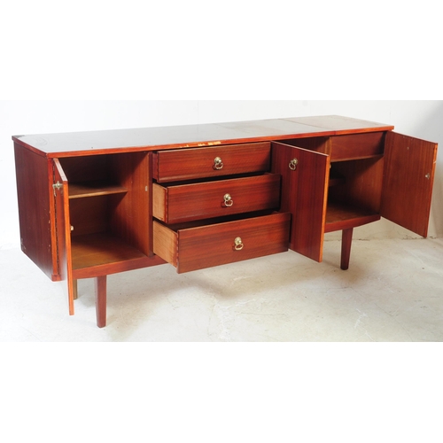 723 - A 1960s mahogany wood sideboard credenza. Of rectangular form with a bank of four drawers to offset ... 