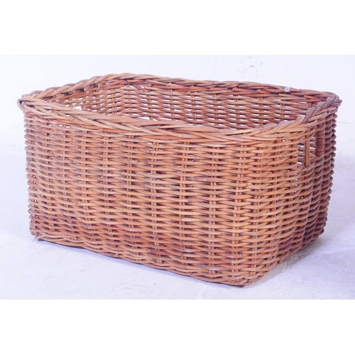 730 - A large mid 20th Century wicker log bin having open top with carry loops. The basket of large size a... 