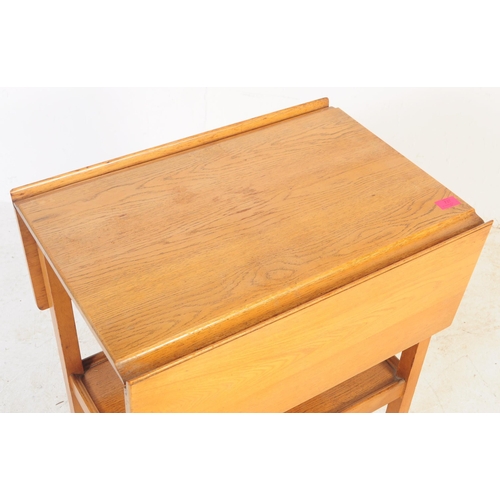 737 - A retro mid 20th century teak serving / butler tray trolley. Rectangular form with drop leaves for e... 