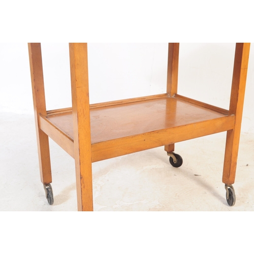 737 - A retro mid 20th century teak serving / butler tray trolley. Rectangular form with drop leaves for e... 