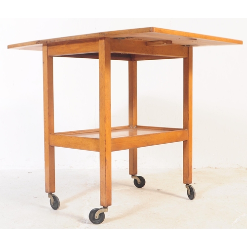 737 - A retro mid 20th century teak serving / butler tray trolley. Rectangular form with drop leaves for e... 