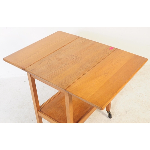 737 - A retro mid 20th century teak serving / butler tray trolley. Rectangular form with drop leaves for e... 