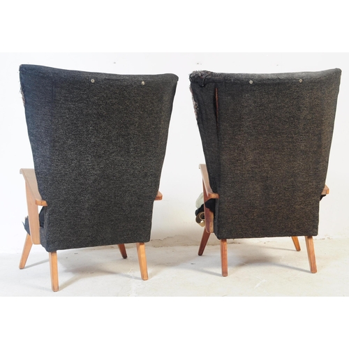 738 - British Modern Design -  A pair of vintage 20th century batwing style sitting lounge armchairs.  The... 