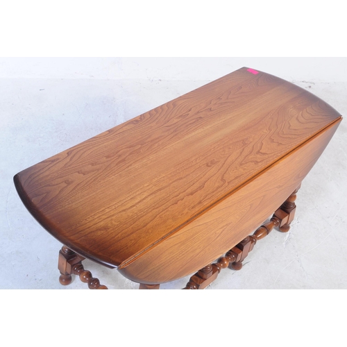 748 - Ercol Furniture - A 20th century Ercol elm and beech wood gate leg coffee table, raised on turned le... 