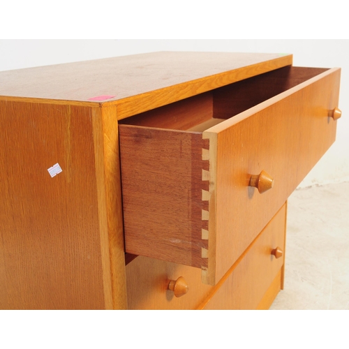 749 - British Modern Design - A mid 20th century oak and teak chest of drawers. Of rectangular form with b... 