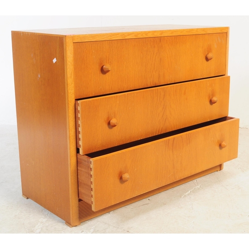 749 - British Modern Design - A mid 20th century oak and teak chest of drawers. Of rectangular form with b... 