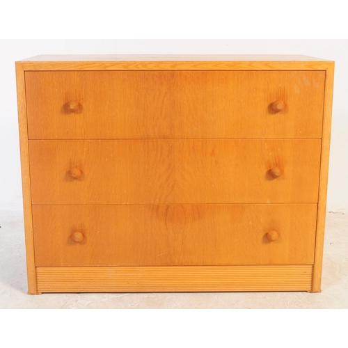 749 - British Modern Design - A mid 20th century oak and teak chest of drawers. Of rectangular form with b... 