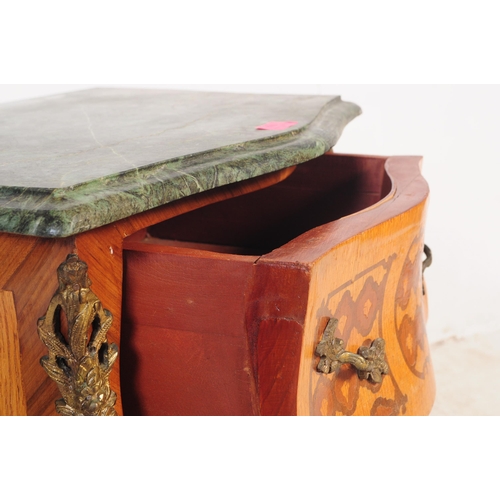 778 - A 19th century revival marquetry inlaid marble topped bombe chest of drawers. The chest having chamf... 