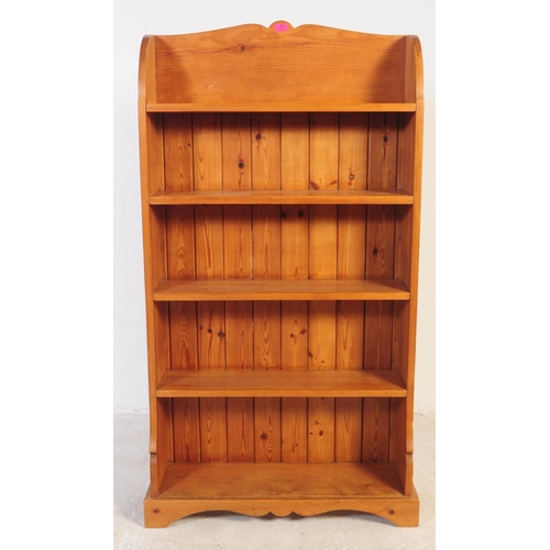 788 - A 20th century country pine free standing window bookcase. The bookcase having rounded top over a wi... 