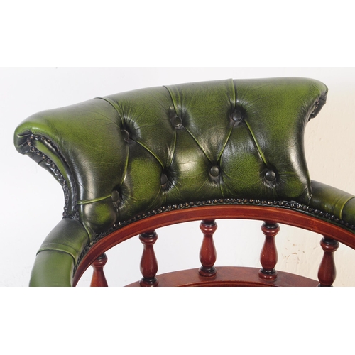 799 - A  Chesterfield style green leather captain's office swivel desk armchair. The chair having button b... 