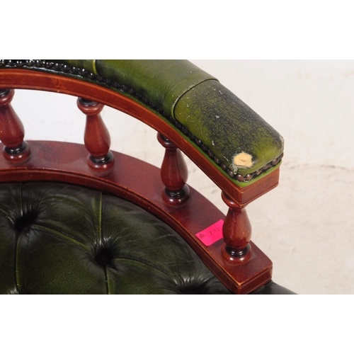 799 - A  Chesterfield style green leather captain's office swivel desk armchair. The chair having button b... 