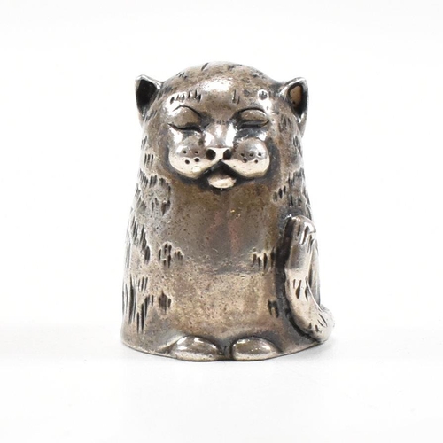 1 - A hallmarked silver novelty thimble in the form of a dozing cat. Hallmarked London 1987. Sponsors ma... 