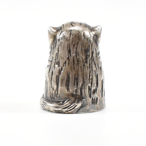 1 - A hallmarked silver novelty thimble in the form of a dozing cat. Hallmarked London 1987. Sponsors ma... 