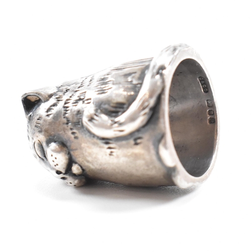 1 - A hallmarked silver novelty thimble in the form of a dozing cat. Hallmarked London 1987. Sponsors ma... 