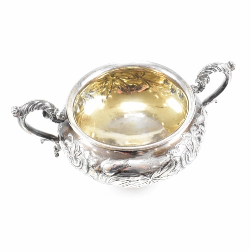 10 - A Georgian hallmarked silver sugar bowl. The George IV bowl having a circular plinth raising to a bu... 