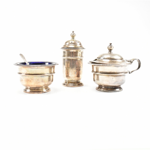 100 - A1930sÿhallmarked silver three piece condiment set. The set comprising of salt, cruet and condiment ... 