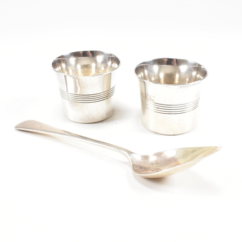 101 - A pair of George VI hallmarked silver condiment pots and spoon. The condiment pots having a striped ... 