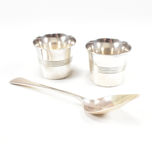 101 - A pair of George VI hallmarked silver condiment pots and spoon. The condiment pots having a striped ... 