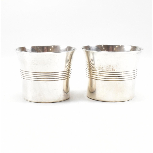 101 - A pair of George VI hallmarked silver condiment pots and spoon. The condiment pots having a striped ... 