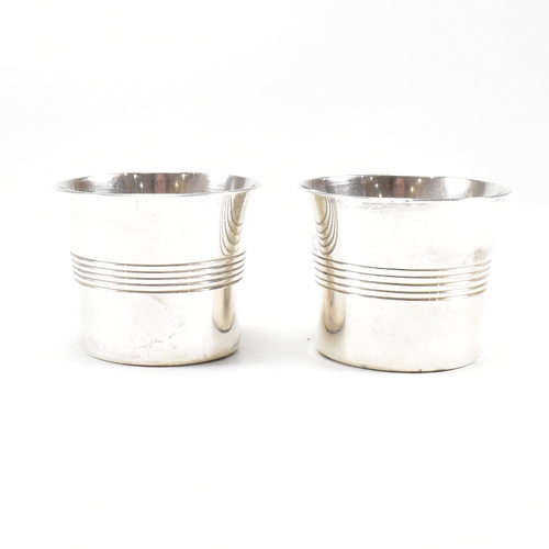 101 - A pair of George VI hallmarked silver condiment pots and spoon. The condiment pots having a striped ... 