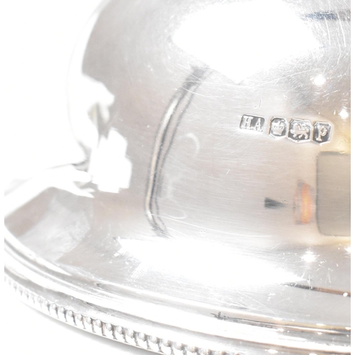 102 - A George V hallmarked silver plate cloche. The meat dome being of circular for with beaded rim risin... 