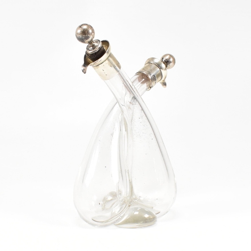 103 - A George V hallmarked silver mounted glass oil and vinegar bottle.ÿHallmarked for Birmingham, 1922. ... 