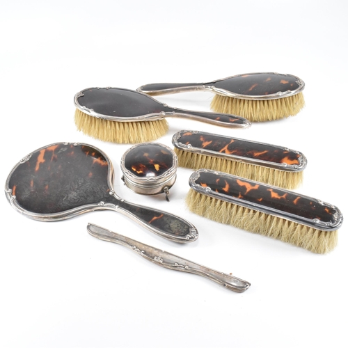 104 - A George V hallmarked silver and tortoiseshell mounted, cased vanity set. The six piece set to inclu... 