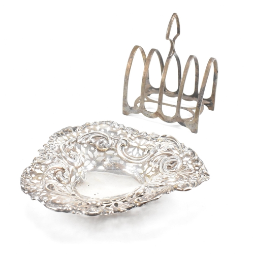 112 - A hallmarked silver toast rack and trinket dish. The Victorian trinket dish having a heart shaped fo... 