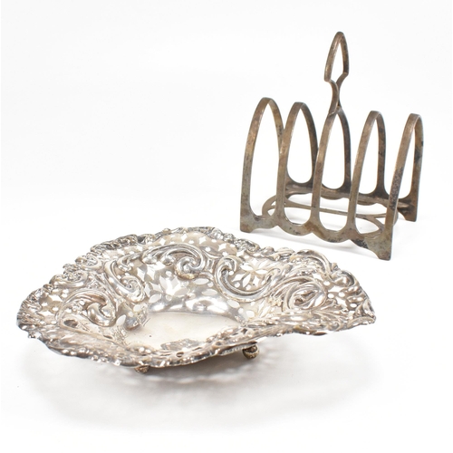 112 - A hallmarked silver toast rack and trinket dish. The Victorian trinket dish having a heart shaped fo... 