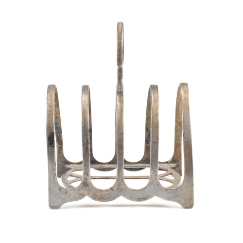 112 - A hallmarked silver toast rack and trinket dish. The Victorian trinket dish having a heart shaped fo... 