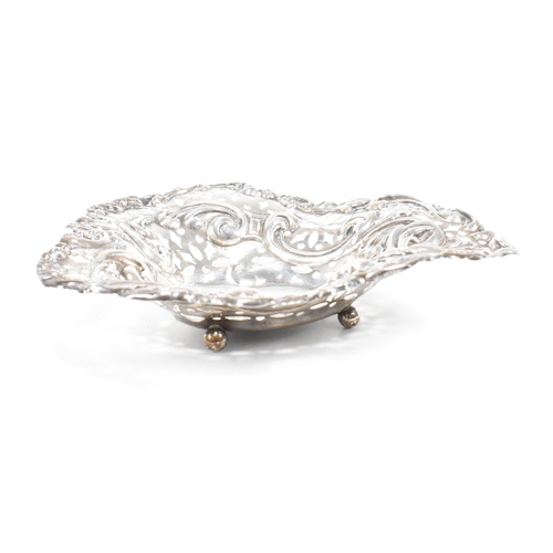 112 - A hallmarked silver toast rack and trinket dish. The Victorian trinket dish having a heart shaped fo... 