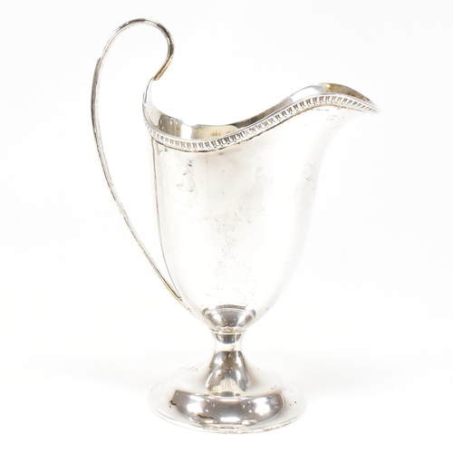 118 - A Victorian hallmarked silver creamer. The creamer jug having a circular plinth base and scrolled ha... 