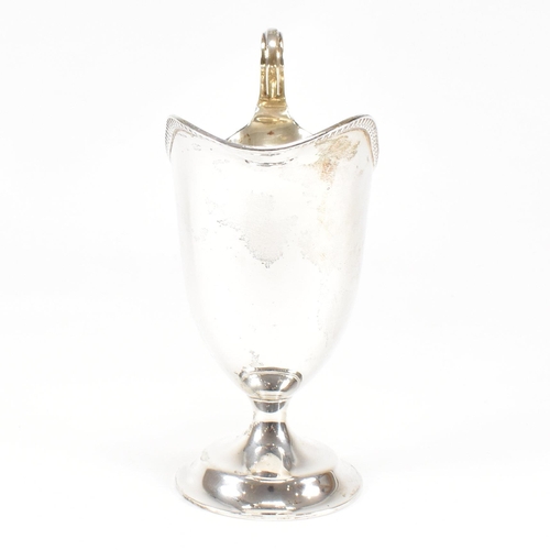 118 - A Victorian hallmarked silver creamer. The creamer jug having a circular plinth base and scrolled ha... 