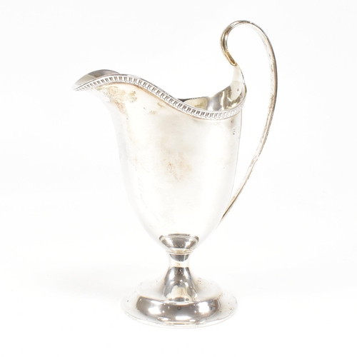 118 - A Victorian hallmarked silver creamer. The creamer jug having a circular plinth base and scrolled ha... 