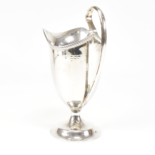 118 - A Victorian hallmarked silver creamer. The creamer jug having a circular plinth base and scrolled ha... 