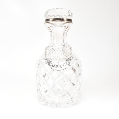 123 - A George VI hallmarked silver collared cut glass decanter. Hallmarked for London, 1936.The decanter ... 