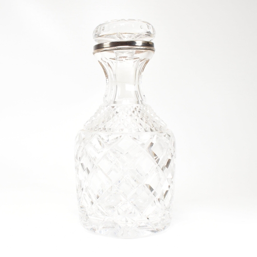 123 - A George VI hallmarked silver collared cut glass decanter. Hallmarked for London, 1936.The decanter ... 