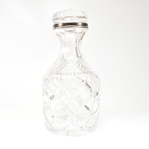 123 - A George VI hallmarked silver collared cut glass decanter. Hallmarked for London, 1936.The decanter ... 