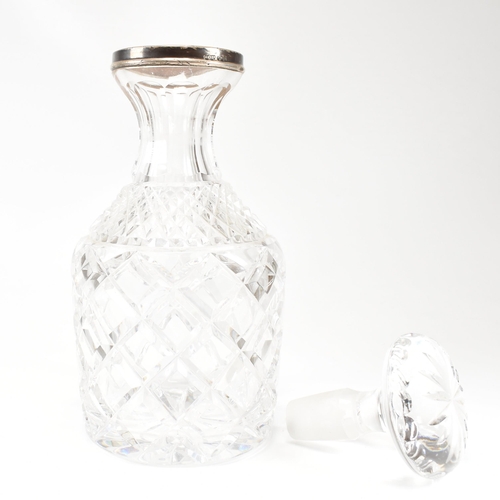 123 - A George VI hallmarked silver collared cut glass decanter. Hallmarked for London, 1936.The decanter ... 