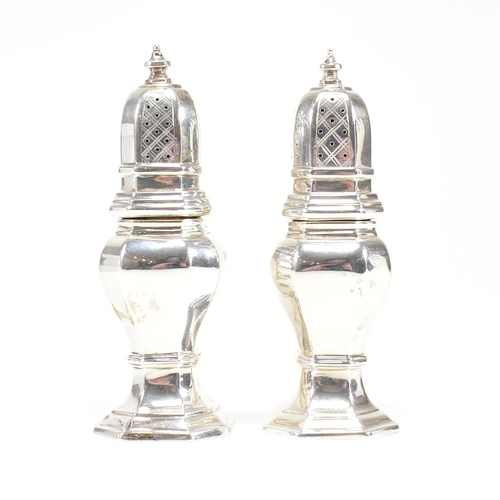 126 - A pair of hallmarked silver cruets. The pepper shakers having an octagonal shape plinth base and bei... 