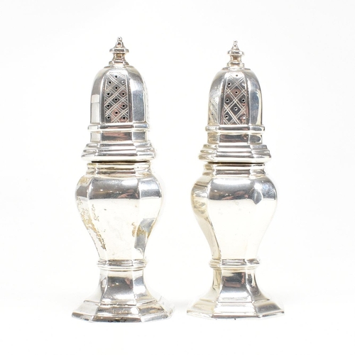 126 - A pair of hallmarked silver cruets. The pepper shakers having an octagonal shape plinth base and bei... 