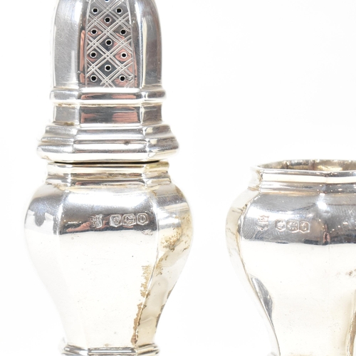 126 - A pair of hallmarked silver cruets. The pepper shakers having an octagonal shape plinth base and bei... 