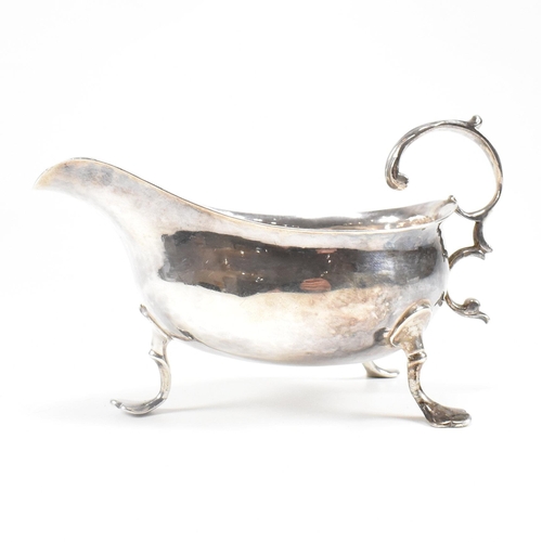 127 - A Georgian hallmarked silver sauce boat. The George III sauce boat having three hoof feet raising to... 