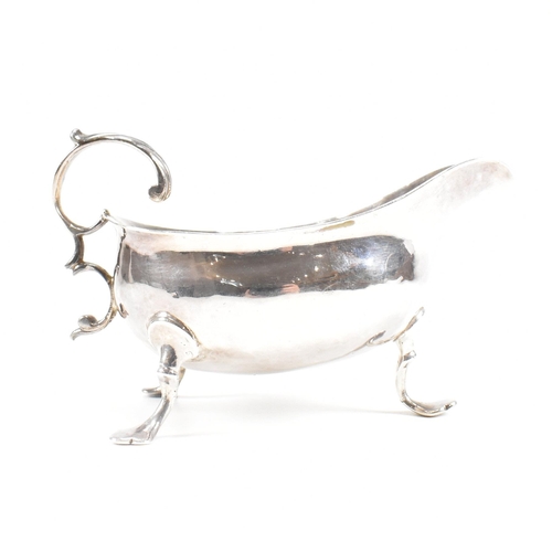 127 - A Georgian hallmarked silver sauce boat. The George III sauce boat having three hoof feet raising to... 