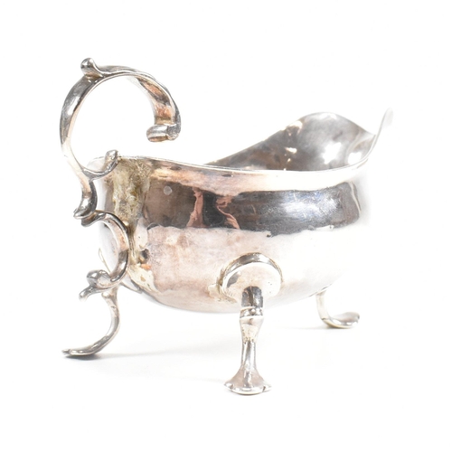 127 - A Georgian hallmarked silver sauce boat. The George III sauce boat having three hoof feet raising to... 