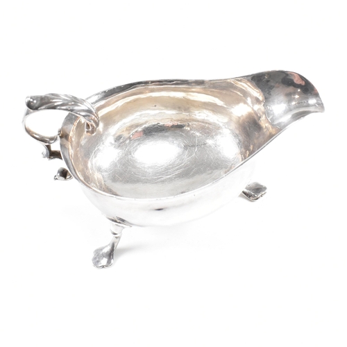 127 - A Georgian hallmarked silver sauce boat. The George III sauce boat having three hoof feet raising to... 