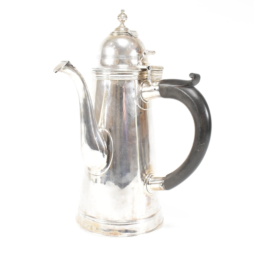 129 - An Edwardian hallmarked Britannia silver coffee pot. The Edward VII pot having a hinged lid, finial ... 